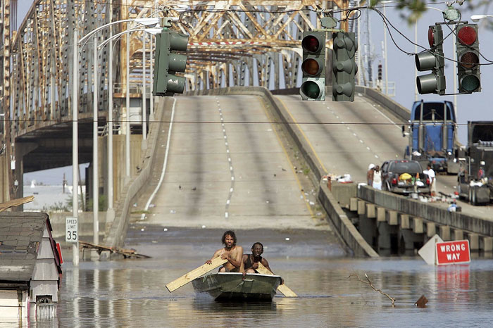 9) Two men get around in a boat in New Orleans following Hurricane Katrina, 2005 (US)