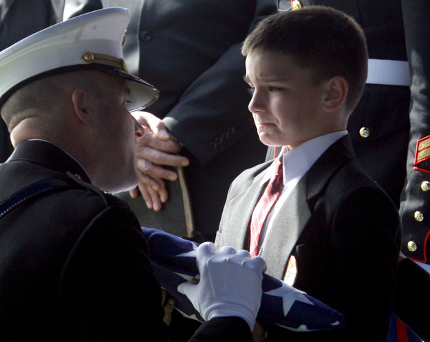 11. When 8 year-old Christian Golczynski accepts the flag for his father, Marine Staff Sgt. Marc Golczynski, who died in Iraq