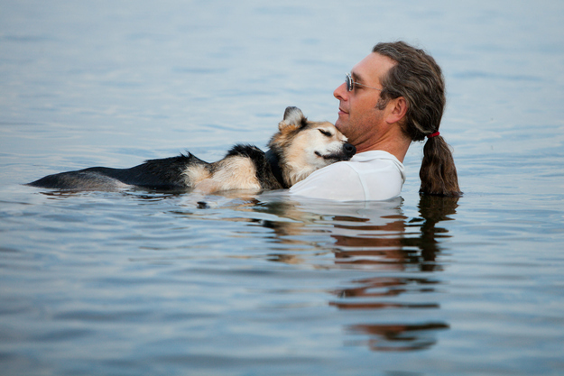 9. When this old dog's loving owner cradled him in water to help ease his friend's arthritis pain