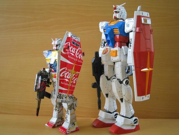 4. Gundam robot made from cans next to an actual Gundam robot action figure.
