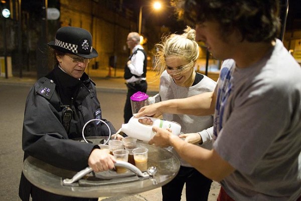 8.) Protestors offer tea to riot police in London in 2011.