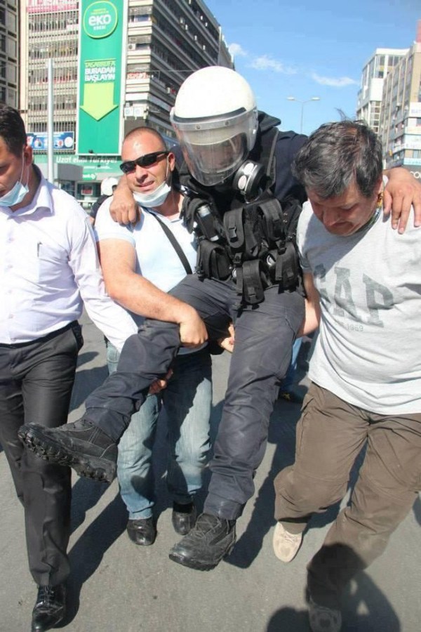 18.) Protestors carry an injured police officer to safety during protests in Turkey.