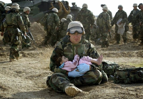 1.) An American soldier holds a child after she was separated from her family during the Iraq War in 2003.