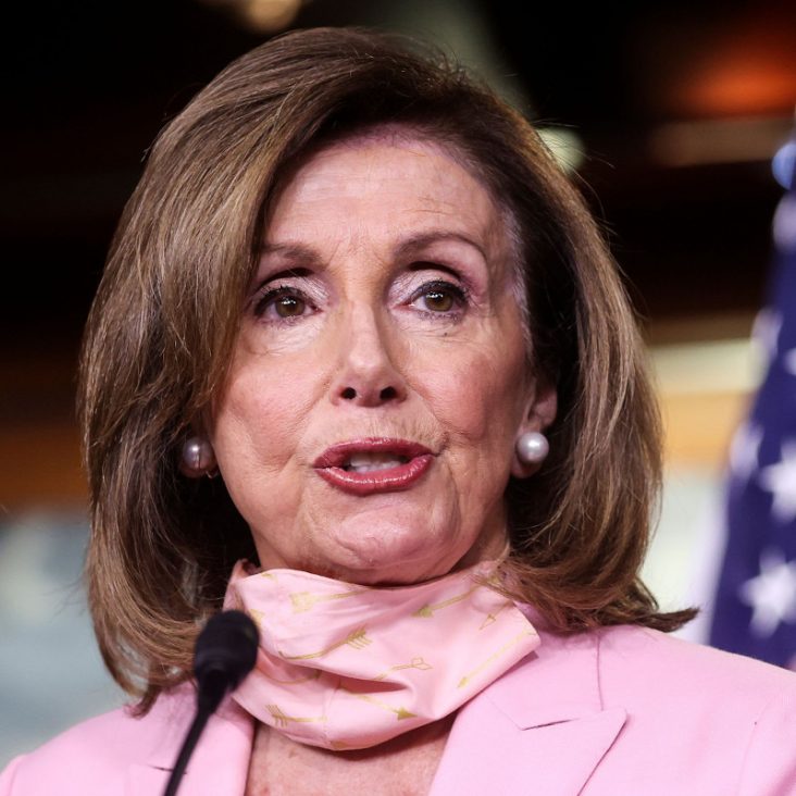 Nancy Pelosi speaking at a podium