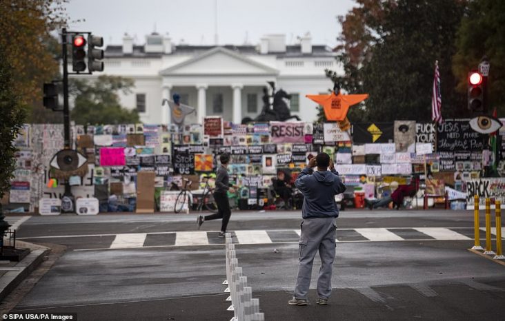 White House Security Fence Covered With Signs Telling Trump To Go