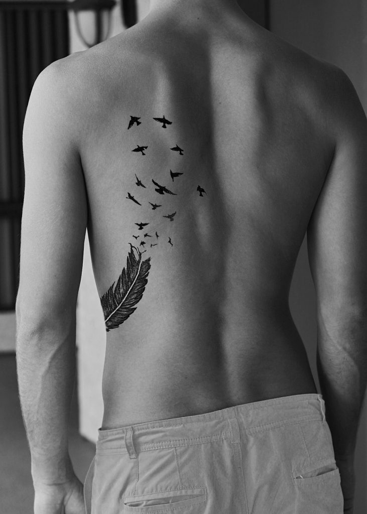 birds tattoo on ribs