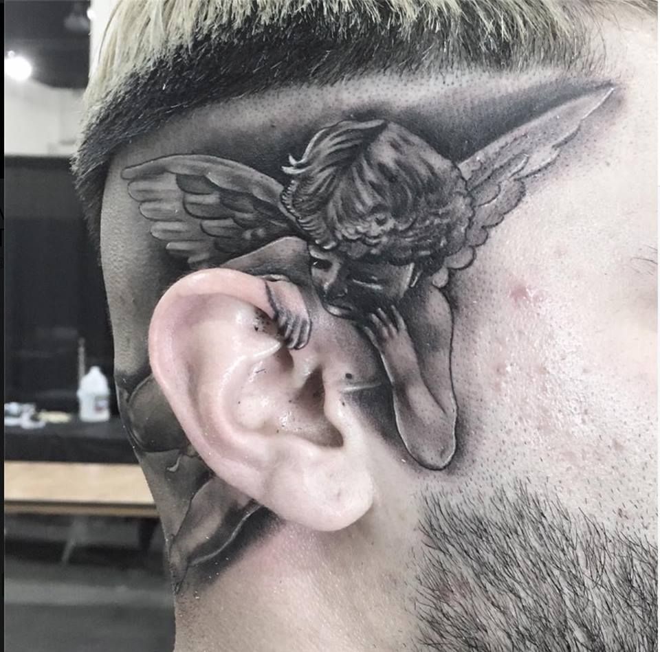 22. Angel Whispering in the Ear Tattoo.