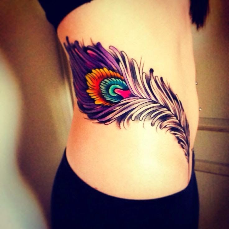 feather tattoo on hip bone