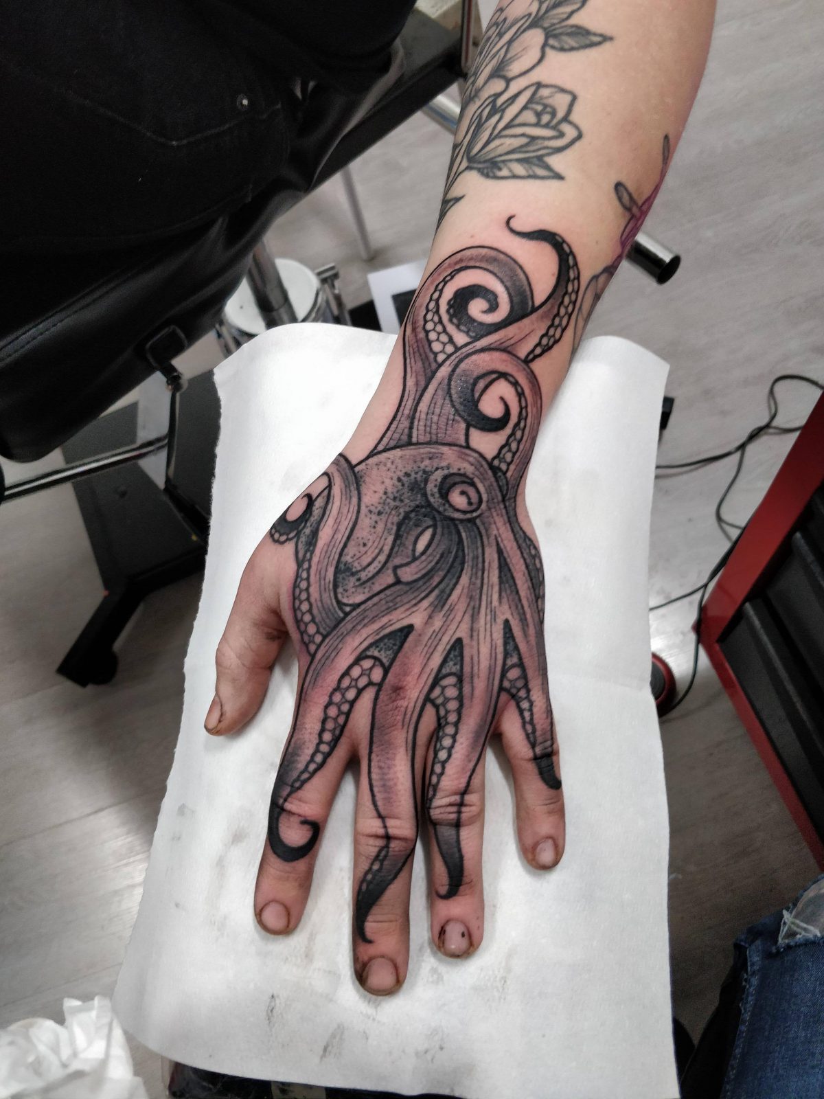 Octopus finger tattoo