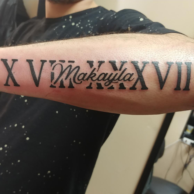 25 Roman Numeral Tattoos For Smart Men   24. Roman Numerals And Name Tattoo 