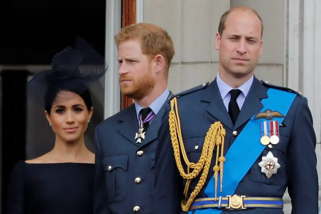 Prince Harry, Meghan, Prince William, and Catherine standing on the balcony of Buckingham Palace during the RAF centenary event