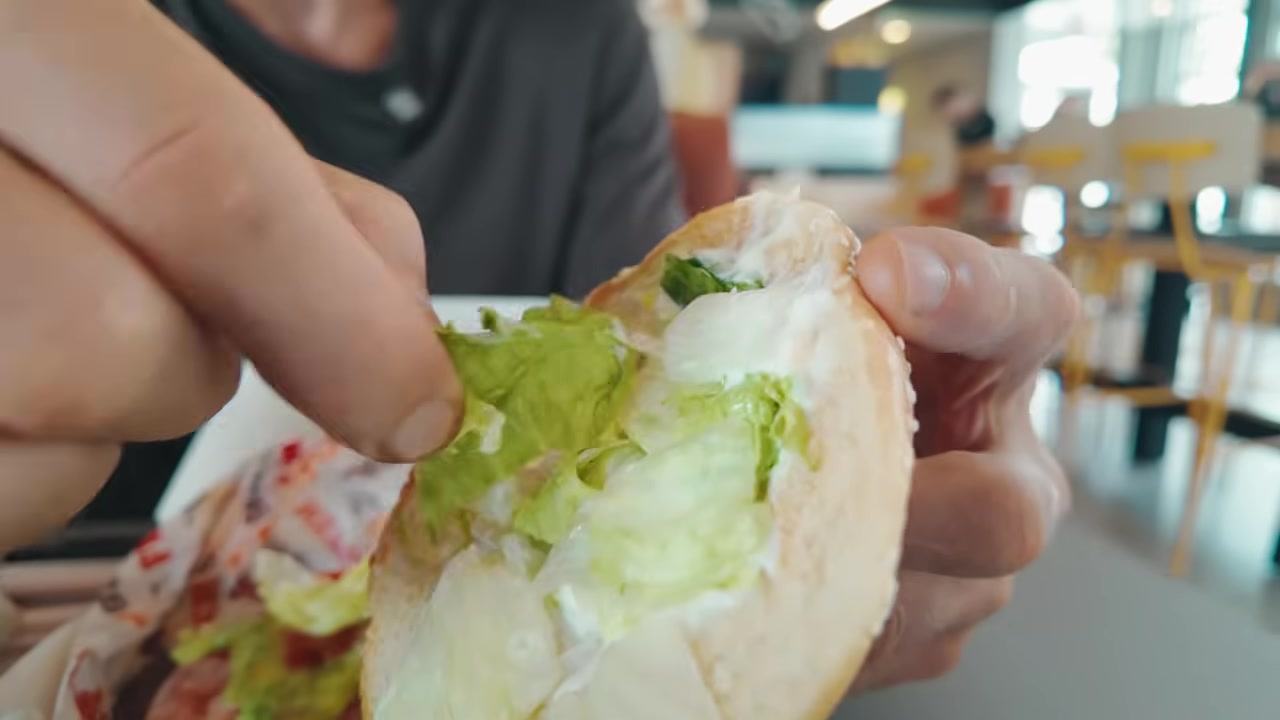 Close-up of mayonnaise being examined, showing its creamy texture