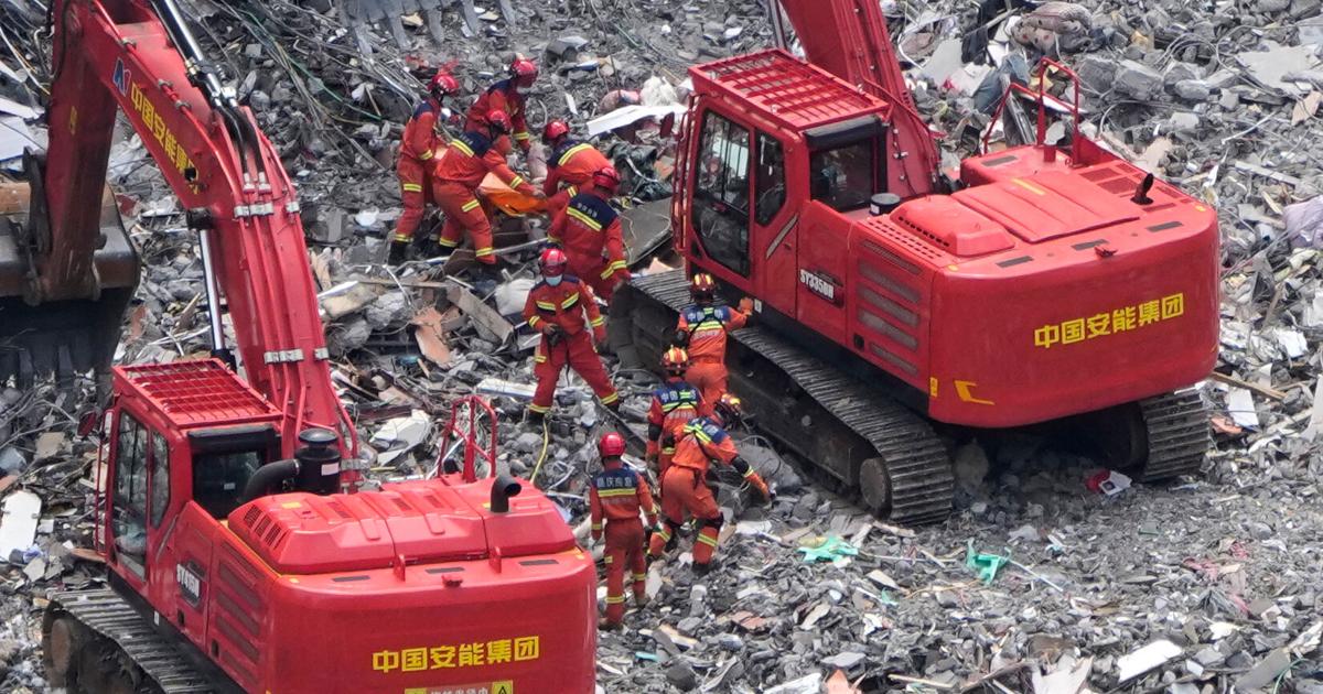 Rescue workers conducting search operations among rubble