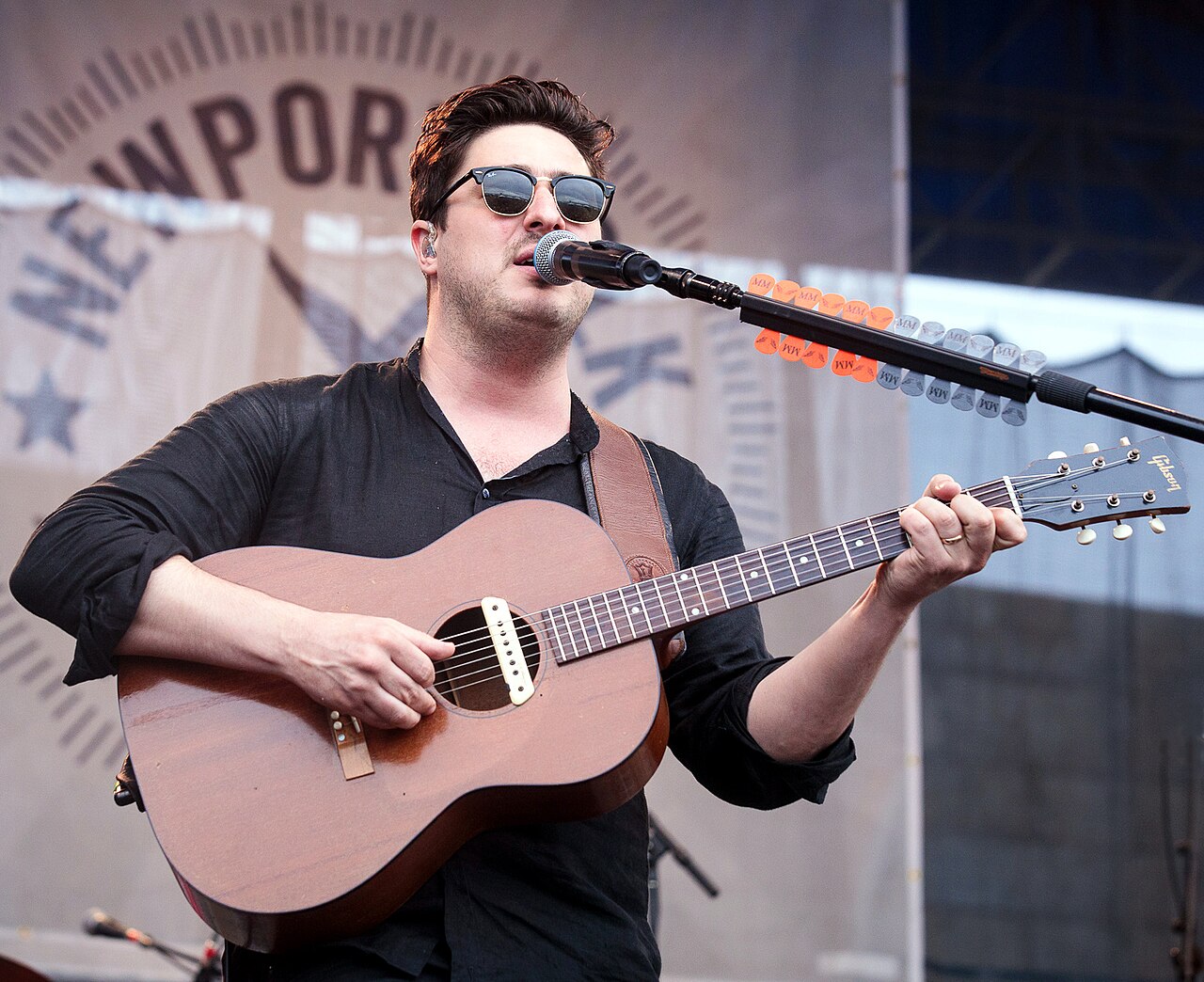 Marcus Mumford performing with Mumford & Sons