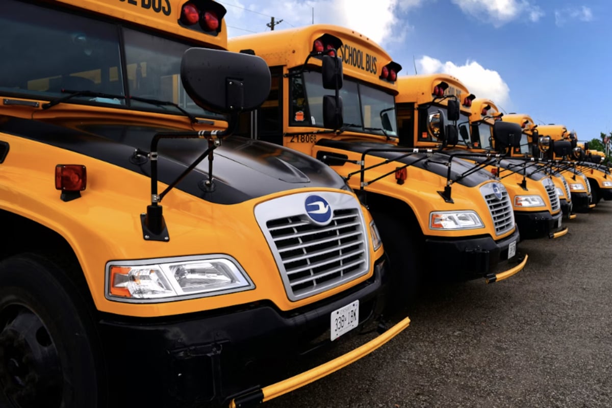 Moment teen girl on an e-scooter is mowed down by a school bus in front of her friend