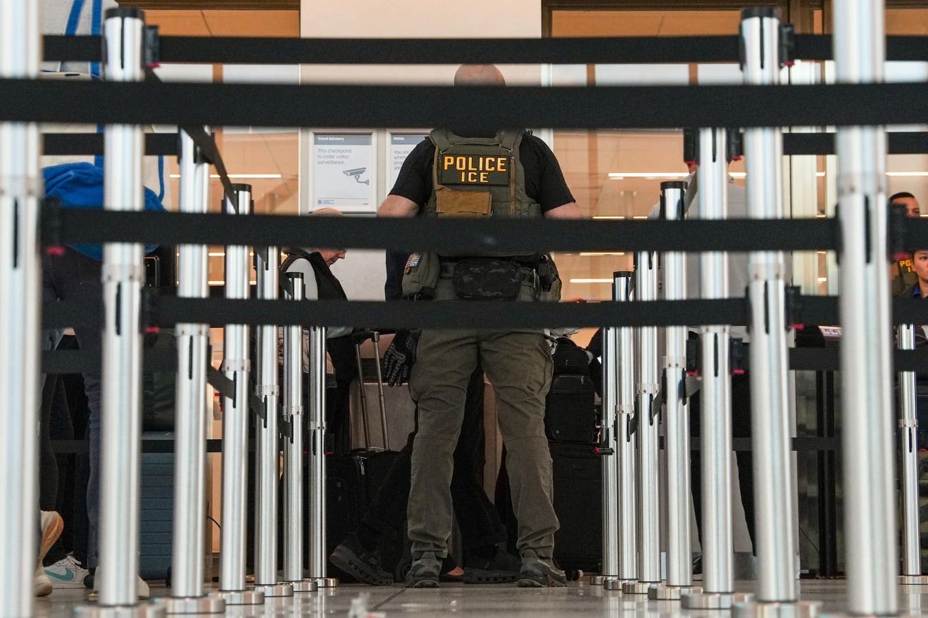 ICE agents conducting enforcement operations at U.S. airports.