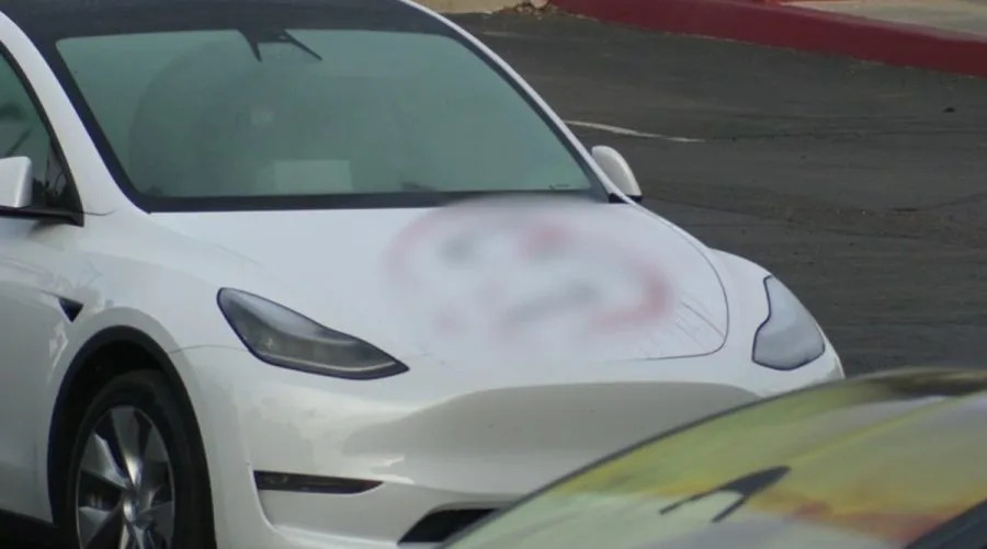 Vandal busted after scrawling vile messages across 13 Teslas in California