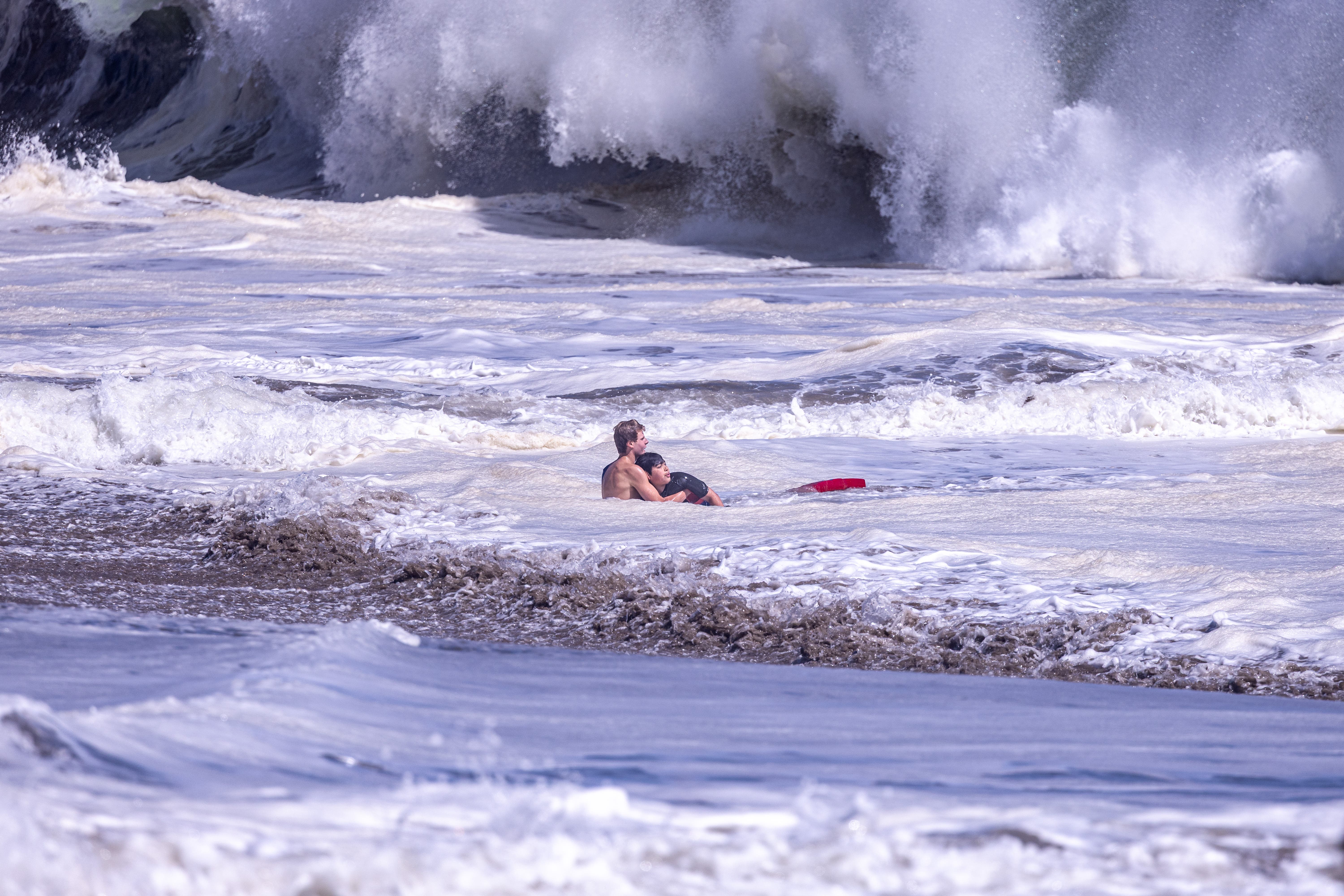 California lifeguard is hailed as a hero after rescuing a boy from pounding surf