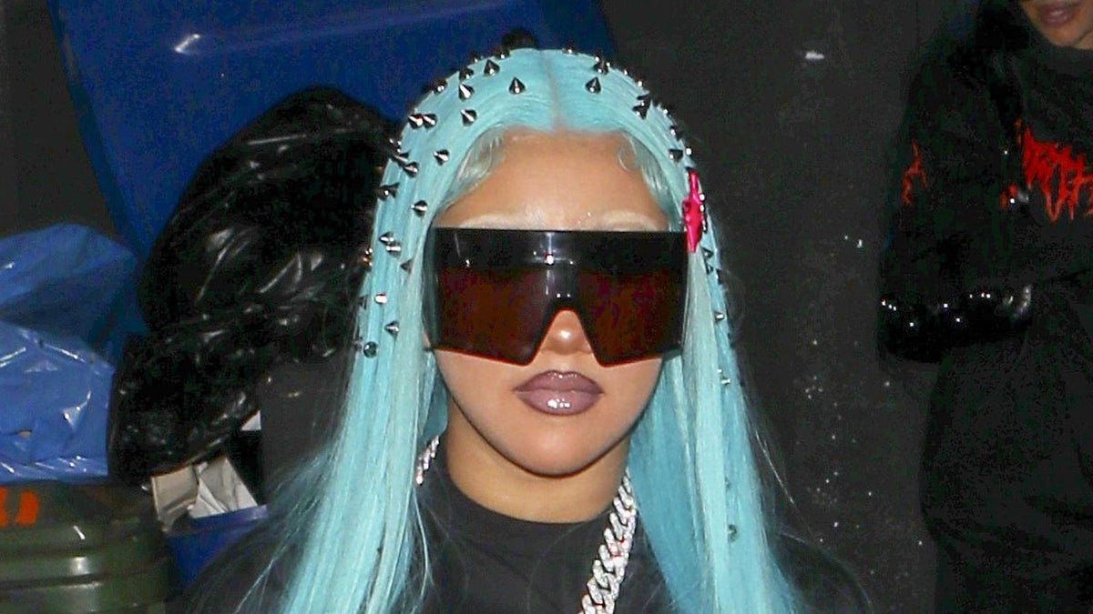 North West in black outfit at Paris Fashion Week with facial piercings