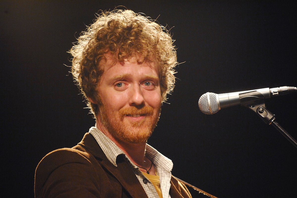 Glen Hansard as younger man, early in his music career busking Dublin streets
