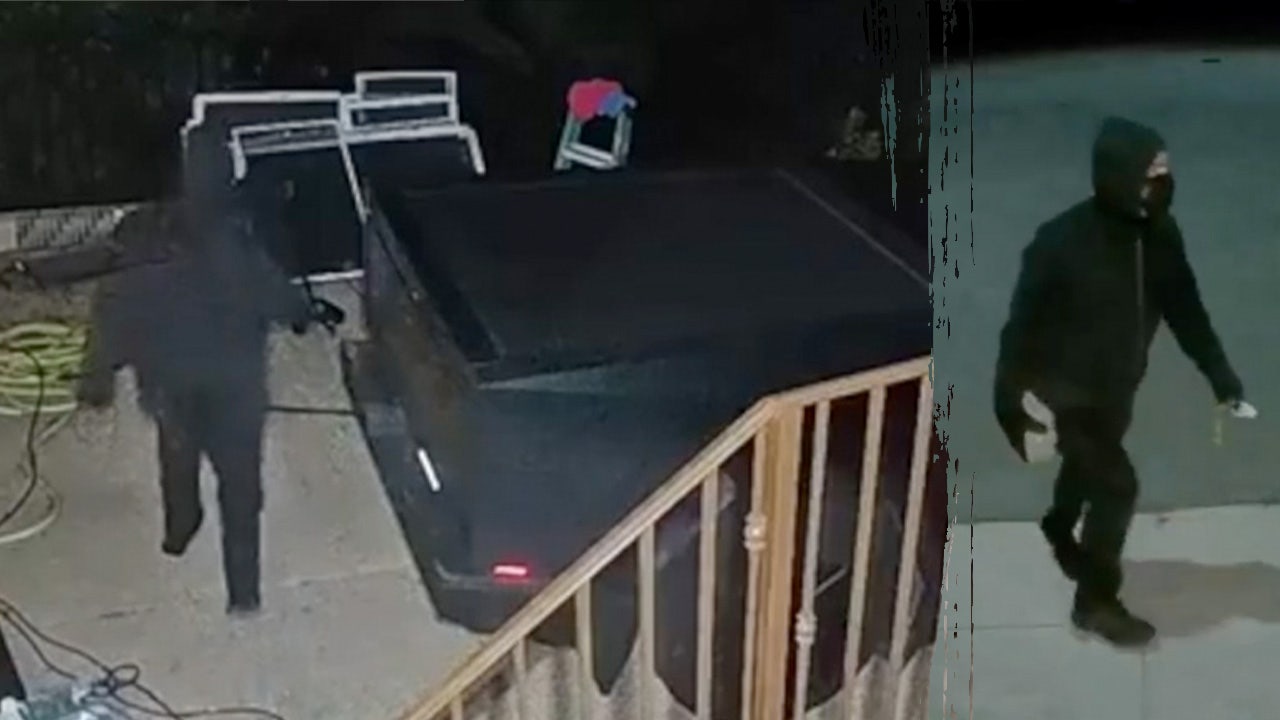 Vandalized Tesla with red spray paint messages