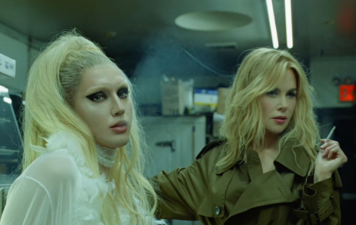 Nicole Kidman cozies up to young pop star, smokes cigarette and downs shot in raunchy music video
