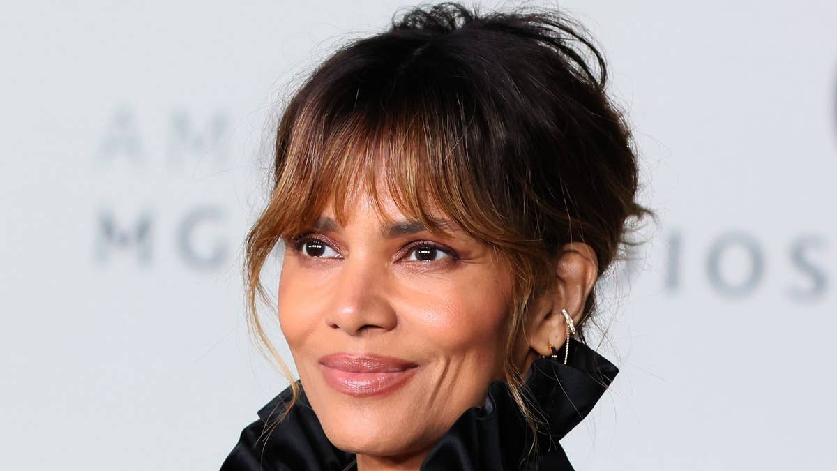 Halle Berry reclining in a relaxed poolside pose during her Fiji getaway.