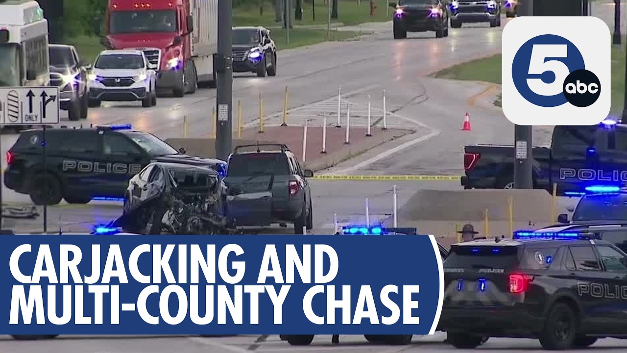 Police officers pursuing and apprehending the suspect after he fell from the car