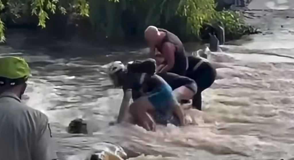 Woman miraculously survives being sucked through flood tunnel as rescuers become victims themselves trying to pull her out