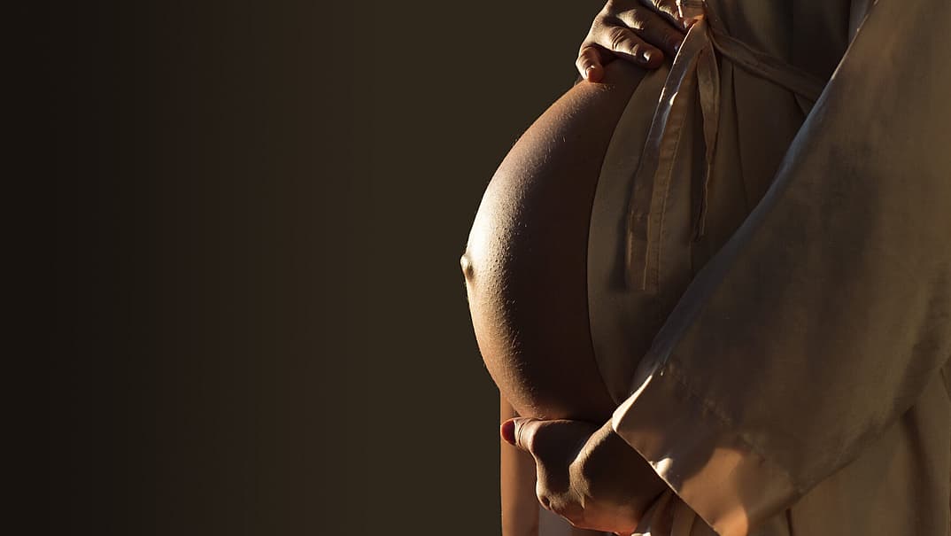 Surrogate mother refusing to abort baby despite biological parents' request to be recognised as birth mother