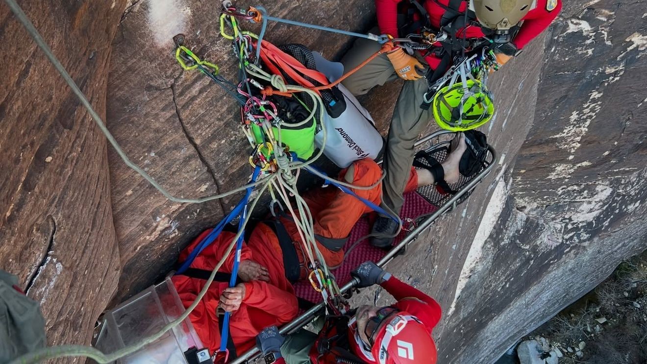 Chilling moment solo climber hangs off a cliff as rescuers desperately try to reach him