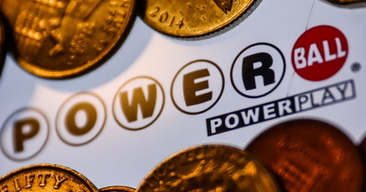 An American lottery retailer displaying Powerball promotional signage in their window.