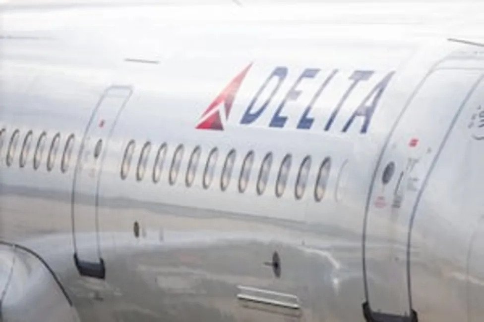 Emergency evacuation slides deployed on taxiway with passengers evacuating