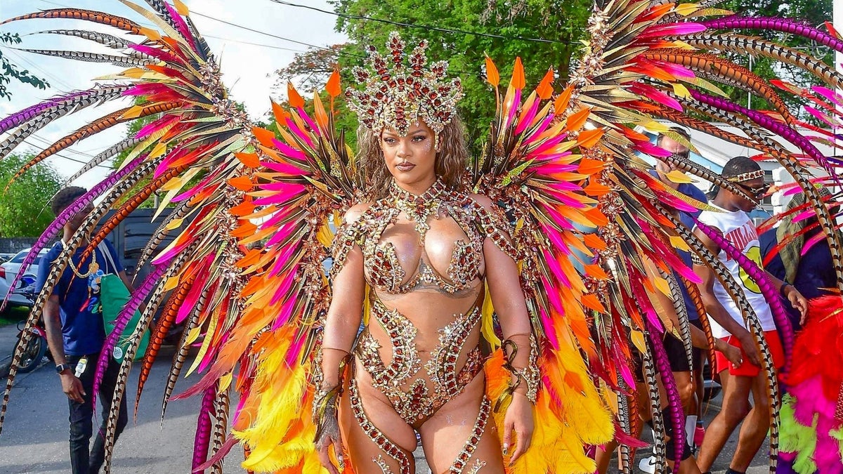 Rihanna showing off the towering feathered headdress and jeweled details of her costume