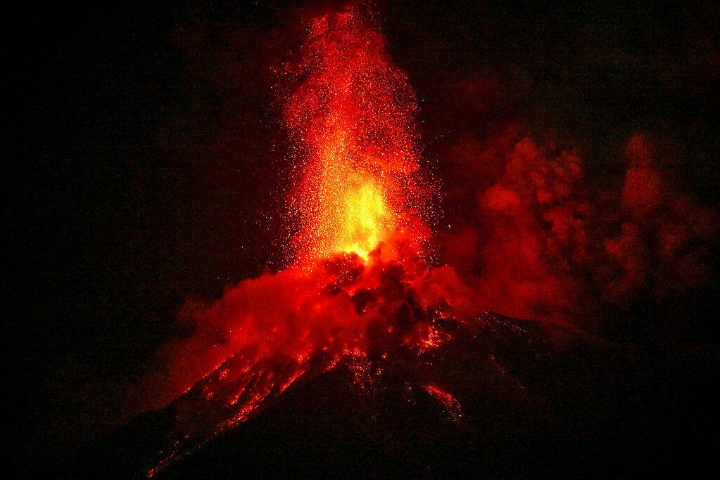 Families evacuated from the volcano arriving at a temporary shelter in San Juan Alotenango