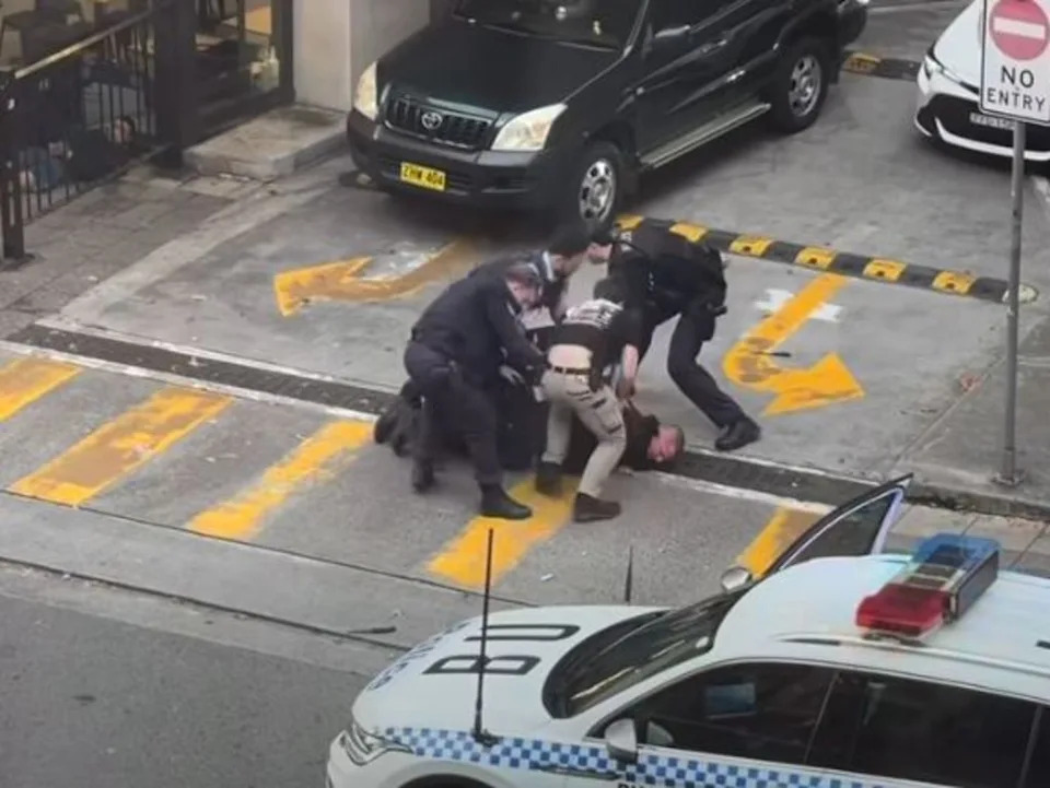 Officers deploying Taser on the suspect during the foot pursuit