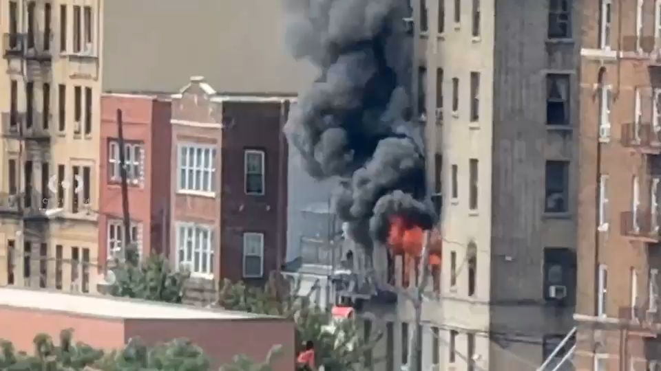 Firefighters battling the five-alarm blaze on the upper floors