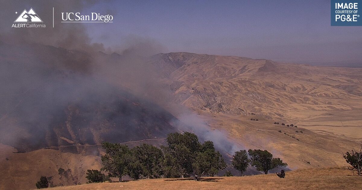 Firefighting helicopters drop water on the rapidly spreading Buzzard Fire.