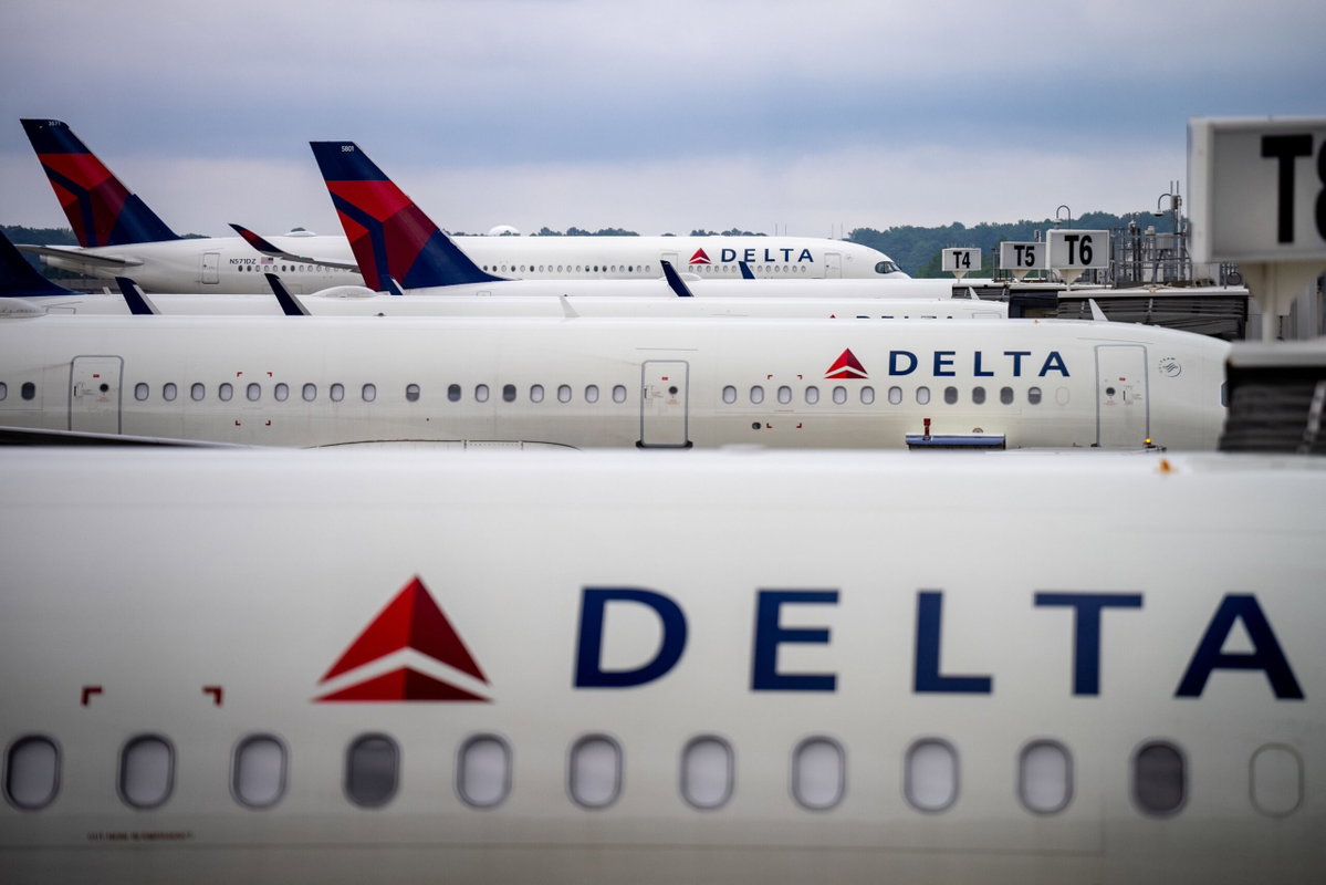 Passengers standing on tarmac after emergency evacuation