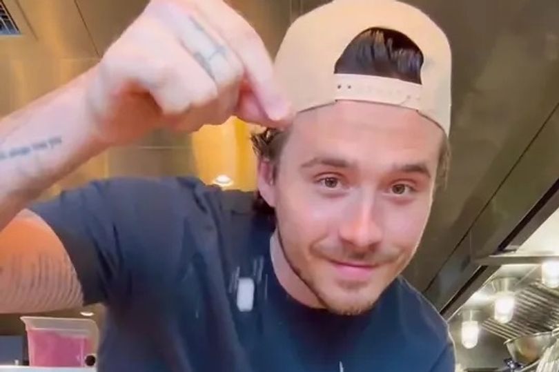 Brooklyn Beckham scooping seawater from the ocean into a saucepan aboard a luxury yacht.