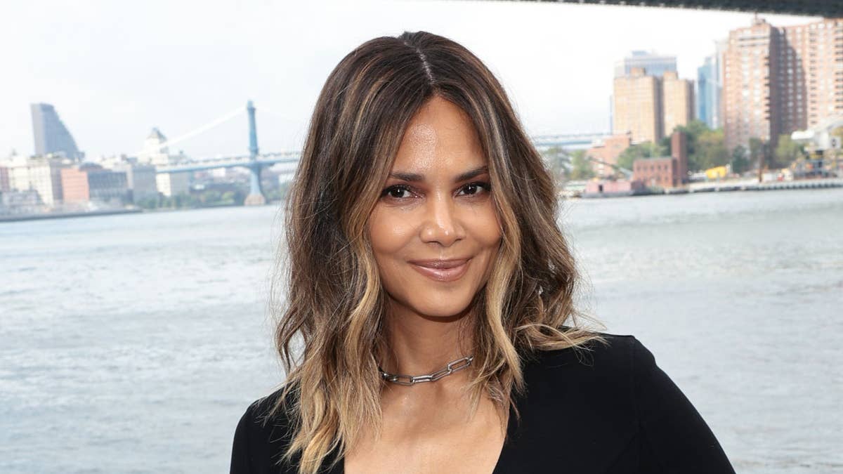 Halle Berry, 59, at the side of an infinity pool on vacation.