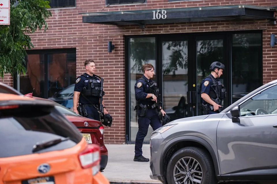 Detective Matthew Gale leaving Kings County Hospital surrounded by fellow officers