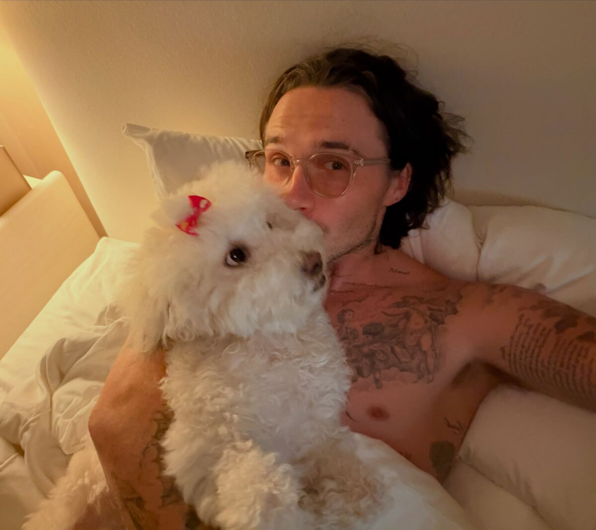 Brooklyn Beckham shares intimate bed snaps with Nicola Peltz as dad David plays happy family amid feud