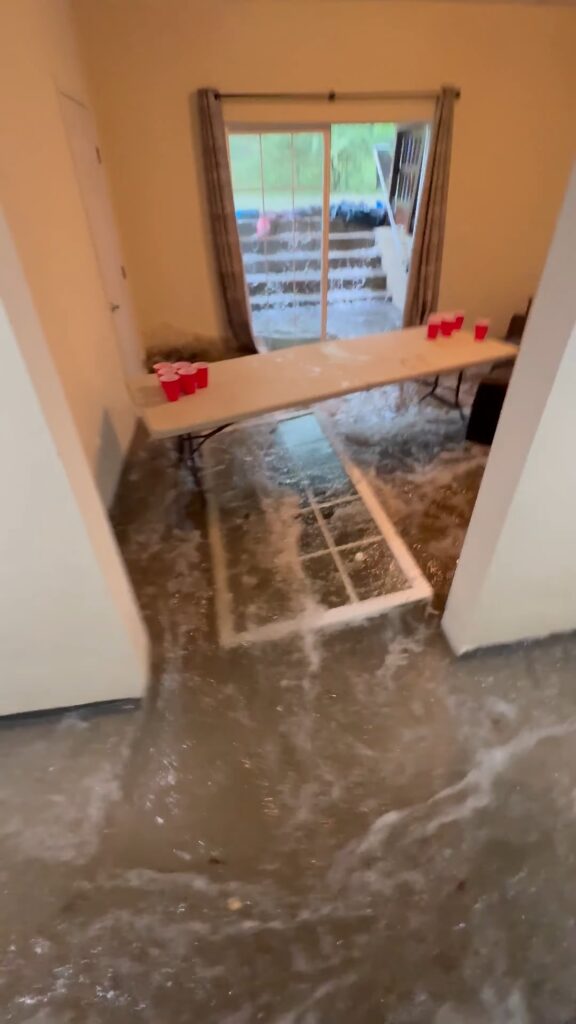 Dramatic video captures floodwaters bursting through glass doors of college students’ home
