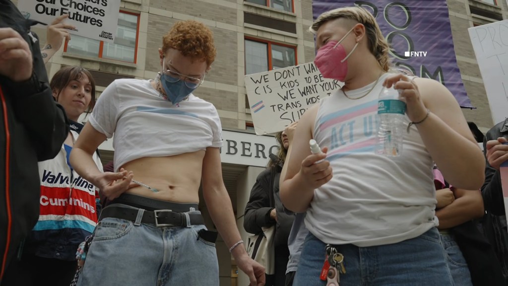 Trans activists inject themselves with hormones in viral stunt protesting Trump’s DOJ deal