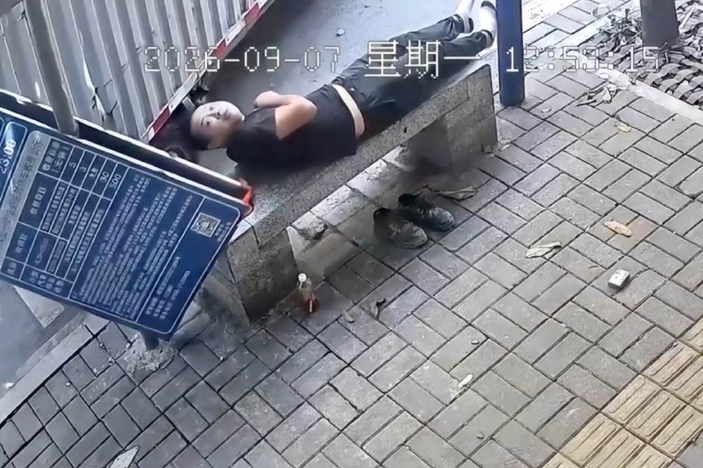 Oblivious napper escapes death as billboard torpedoes into bench inches from his head: video