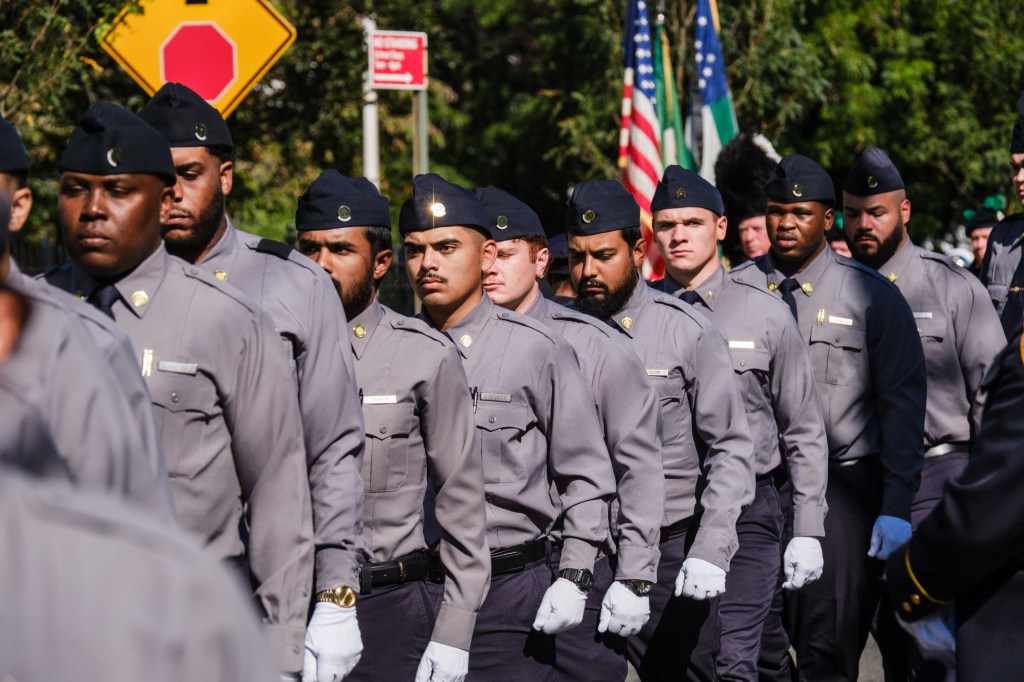 Heartwrenching funeral photos capture tearful young daughter of NYPD recruit who collapsed during run at Police Academy