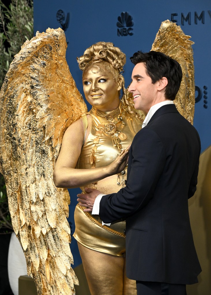 Meg Stalter is a life-sized Emmys 2026 statuette on the red carpet