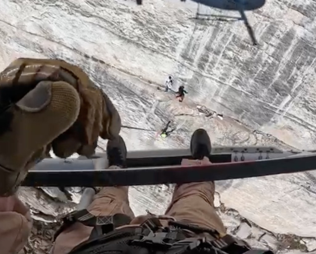 Harrowing moment helicopter hovers frighteningly close to cliff face to rescue fallen climber
