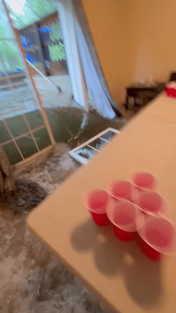 Dramatic video captures floodwaters bursting through glass doors of college students’ home